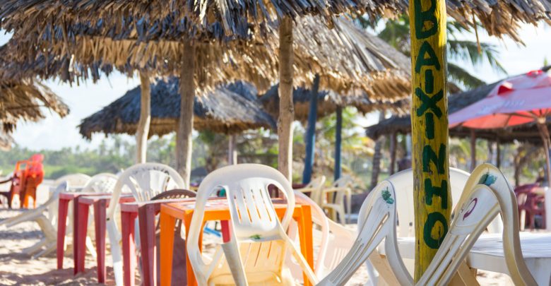 Plastikstühle am Strand von Imbassaí